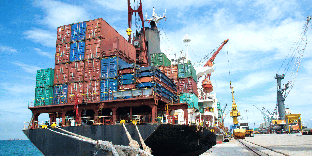 barge boat with many containers at the river dock