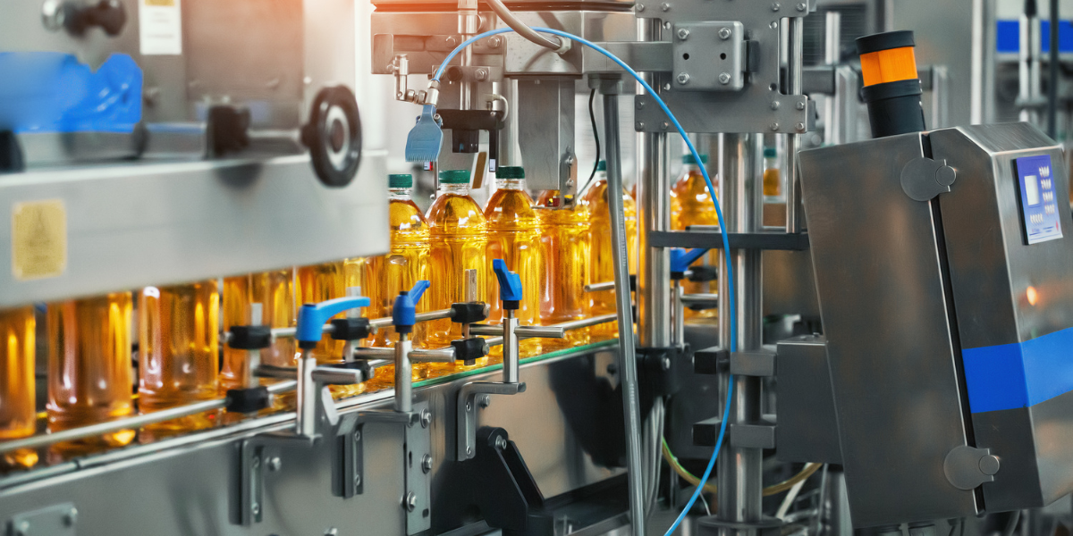 Juice in bottles on conveyor belt, beverage factory interior, industrial production line